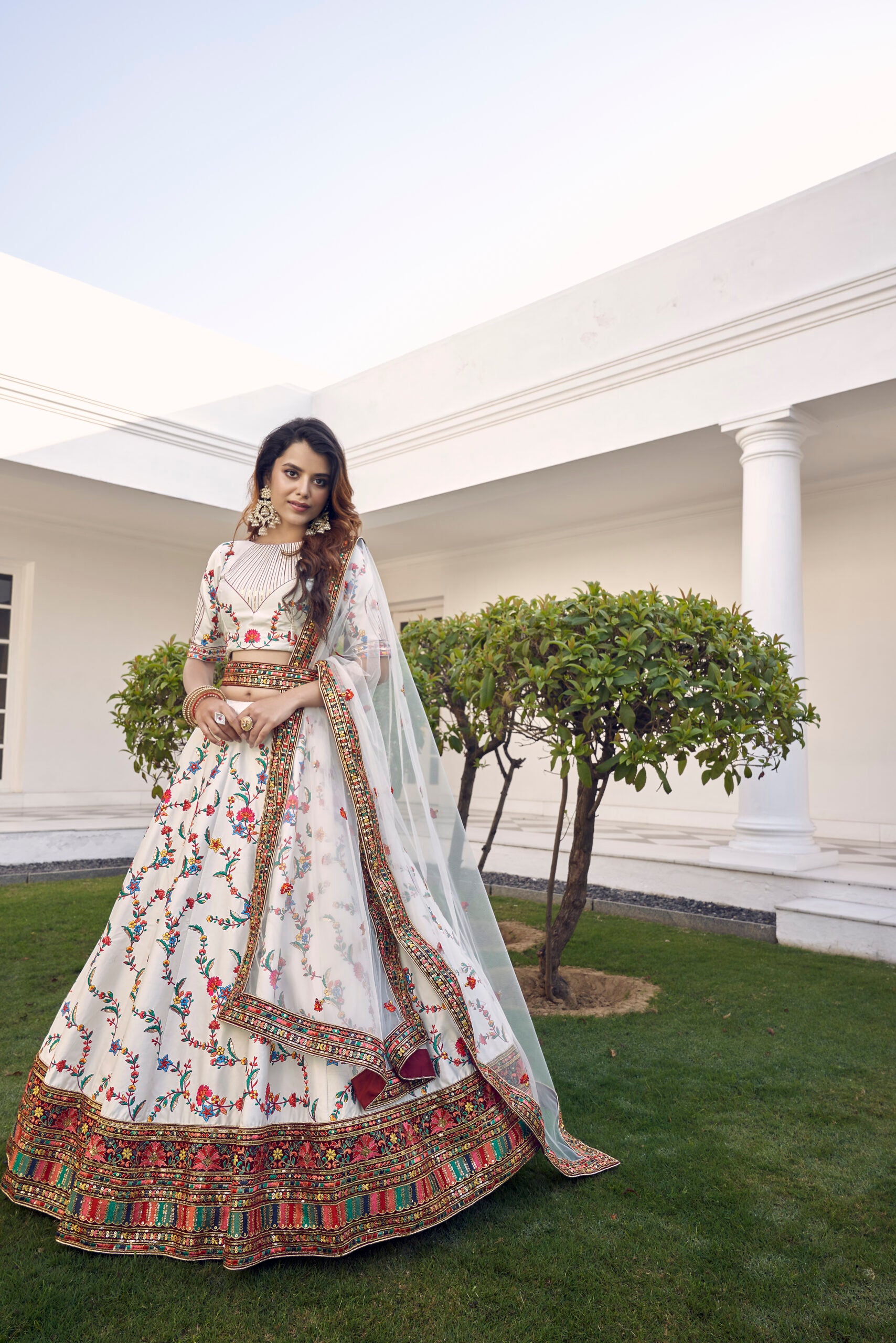 Elegant White Silk Lehenga Choli with Delicate Floral Embroidery and Shimmering Sequins